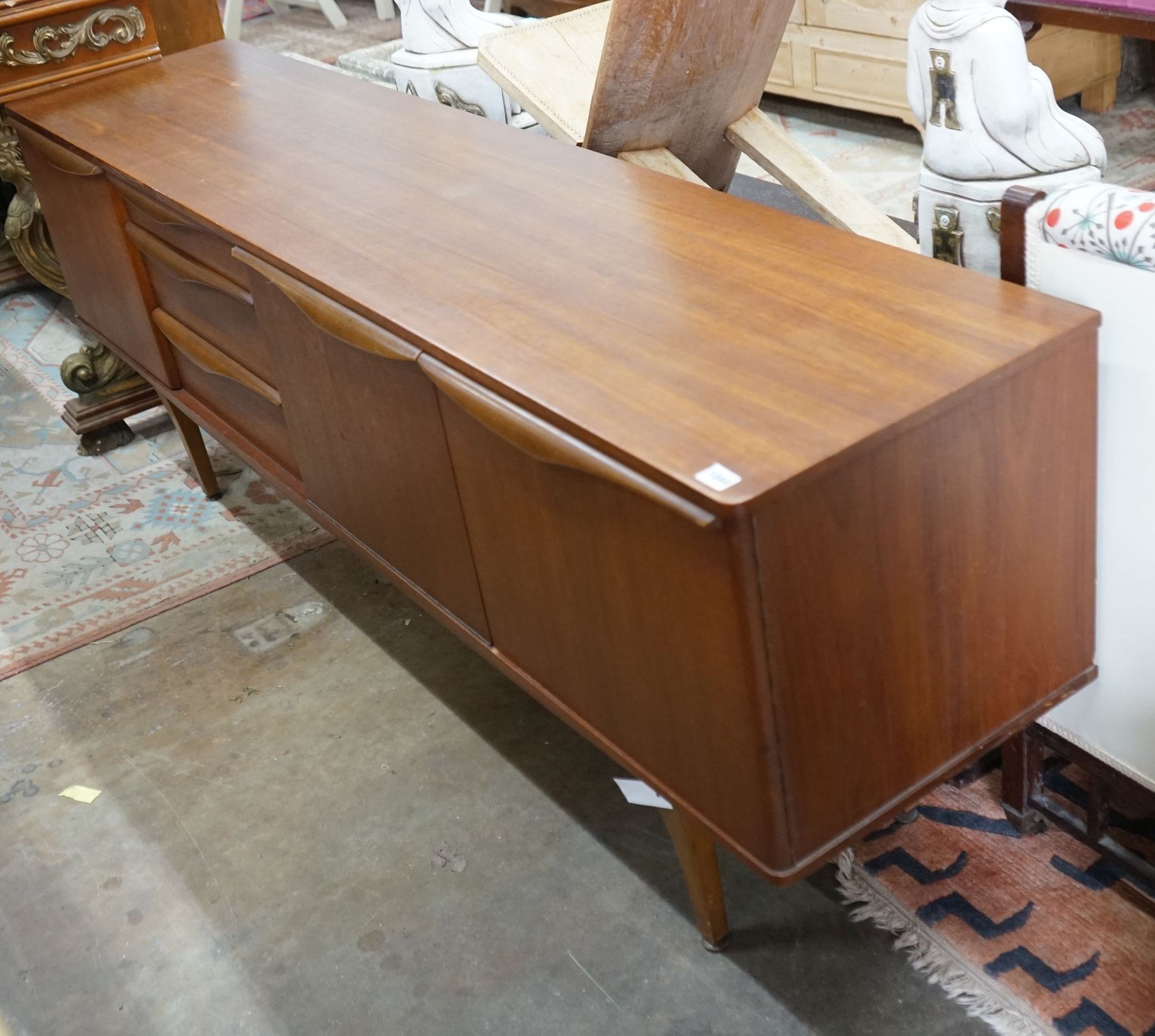 A Stoneleigh mid century teak sideboard, length 198cm, depth 44cm, height 74cm